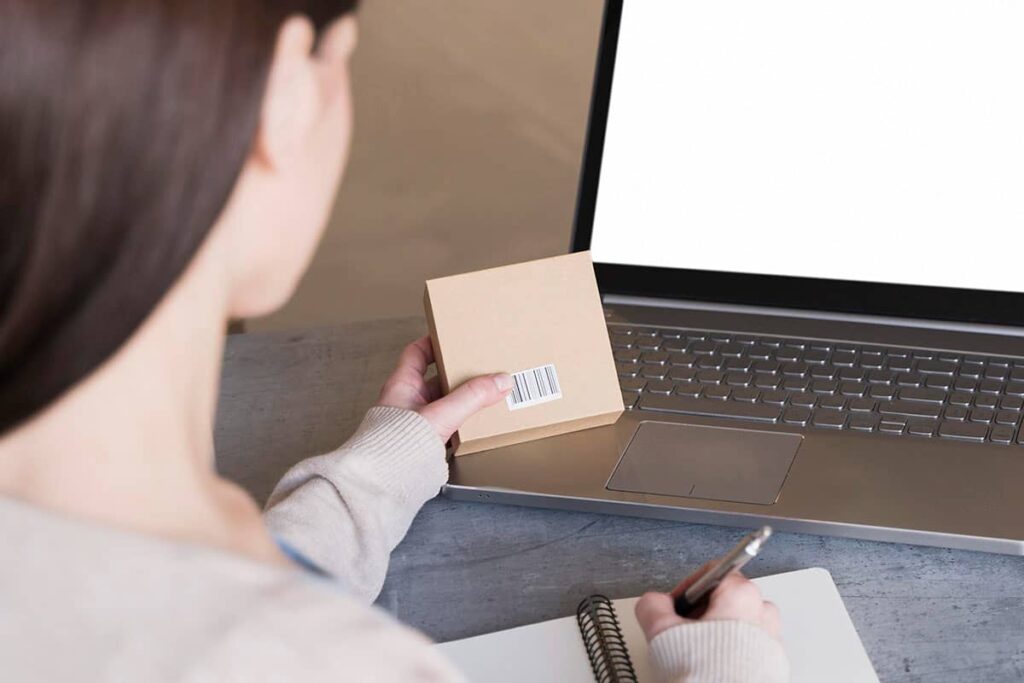 high angle woman working laptop holding box 1