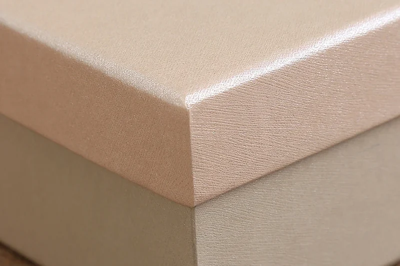 pearlescent box with soft shimmer and blush tones